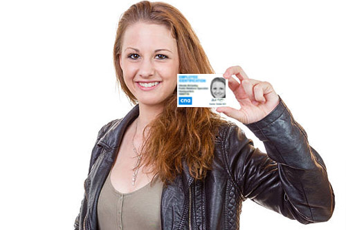 student holding their CNA student ID card